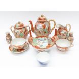 A Japanese Satsuma tea set, comprising of teapot and cover, with damage, two cups, one saucer, sugar