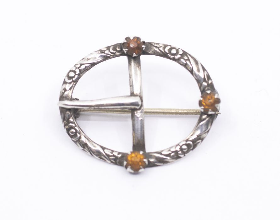 Charles Horner- a silver and citrine coloured paste set brooch in the form of an oval buckle,