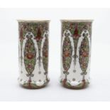 A pair of Royal Worcester shape no: 2510 cylinder vases, floral and jewel painted and applied