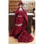 An Ian Stuart ballgown in claret red silk, the bodice of the dress is boned and decorated in lace