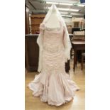 An Ian Stuart shell pink ballgown, the neckline is rushed in the boat neck design, the edging is