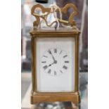 Early 20th Century brass carriage clock, repeating enamel dial and Roman numerals with key