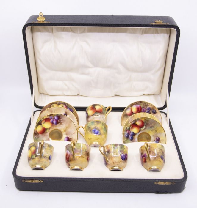 A matched set of six Royal Worcester coffee cups and saucers, all painted with a variety of fruit to