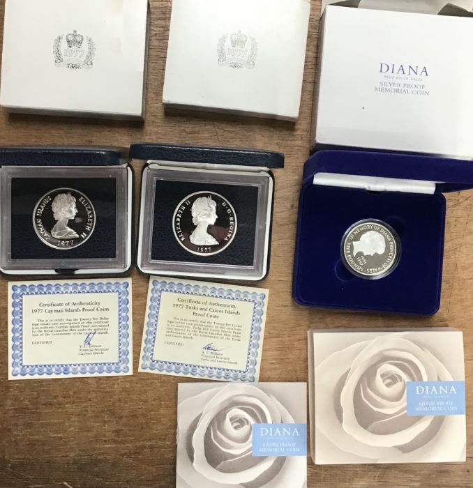 Silver proof coins in original cases with certificates. Includes Diana Memorial £5 coin,1977