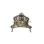 An edwardian silver inkstand, pierced back with scroll borders, integrated pen stand, with a