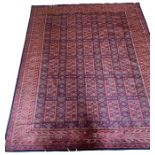 A hand knotted wool rug from Northern india, design 'Tribul', in russet red, burnt oirange and black
