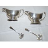 A pair of Georgian style silver sauceboats with beaded border, scroll handle, oval bases, Birmingham