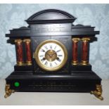 A French style ebony painted mantle clock, 13cm enamel dial with Roman numerals and twin keyholes,