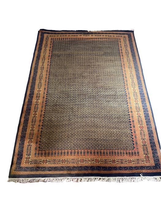 A handmade, hand knotted rug made from wool in Kashmir.. The colours are black, caramel and burnt