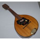 A mandolin with lacquered finish , 61cm long  lovely striped casing to reverse