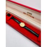 A boxed 9ct gold ladies Bulova wristwatch on a leather strap. Untested. Hallmarked for Birmingham