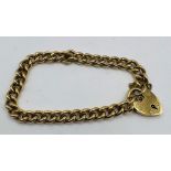 ***AWAY REF CH 27/07***A chunky gold bracelet, with heart padlock and safety chain. Approximate