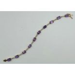 A 9ct gold bracelet, hallmarked for london, set with ten emerald cut lavender Amethyst stones and 54