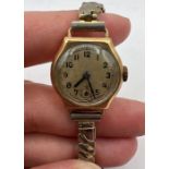 A 9ct gold wristwatch, hallmarked Birmingham 1947, with a gilt stretchable strap. Mechanism