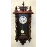 A late 19th century beech cased Vienna wall clock of small size with eight day gong striking