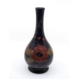 Moorcroft pottery: A Moorcroft pottery bottle vase in Pomegranate pattern. Height approx 31cm. Marks