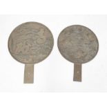 A matched pair of early / mid 20th Century Chinese hand mirrors, cast in relief with birds,