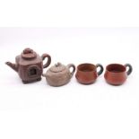 Two small Oriental teapots and 2 cups