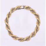 A two tone 18ct gold bracelet, comprising twisted link 18ct yellow gold with a central chain link