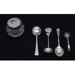 A collection of silver spoons and silver topped glass powder pot, various dates and makers, weight