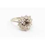 A diamond 18ct white gold cluster ring, with round brilliant cut diamonds, (the central stone
