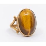 A tigers eye quartz and 9ct gold dress ring, comprising an oval quartz approx 12 x 17mm, to spit