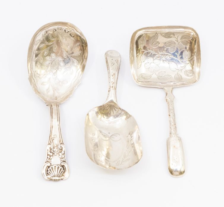 A collection of three 19th Century silver caddy spoons to include: 1. George III bright-cut engraved