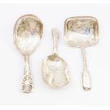 A collection of three 19th Century silver caddy spoons to include: 1. George III bright-cut engraved