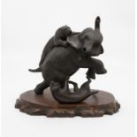 An early 20th Century spelter figure of an Elephant being attacked by two Tigers, unsigned, on