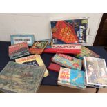 A large collection of vintage board and other games, along with vintage annuals