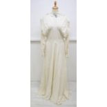 A crepe wedding dress from 27th Sept 1947, the dress is typical of its day, it has a v neckline,