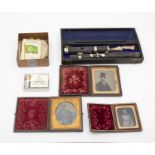 A collection of three Victorian and later ambrotype photographs in leather bound gilt miniature