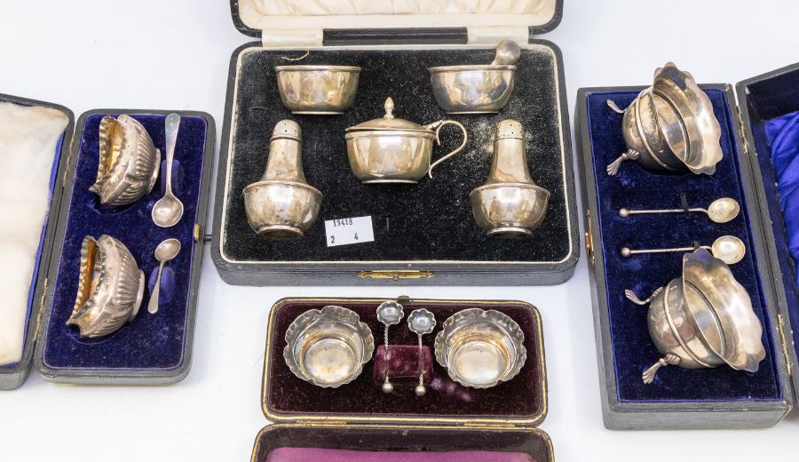 Four various boxed silver cruet sets to include: 1. late Victorian pair of oval gadrooned salts,