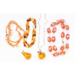 A collection of jewellery to include a mixed amber bead necklace comprising small oval beads of