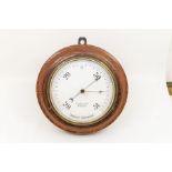 A circular aneroid barometer with J Casartelli & Son, 43 Market Street, Manchester, with 6" white