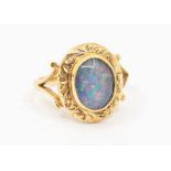 A 9ct gold opal doublet ring, oval shape opal triplet, with fancy decorative border, split