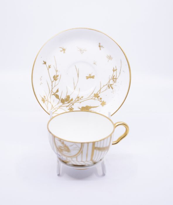 An Aesthetic Movement tea cup and saucer, probably Minton, circa 1875,  the cup with a hand