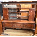 George III oak dresser with three main drawers to base, brass knob handles and cabriole legs, with a