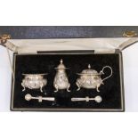 An early 20th Century Indian silver three piece condiment set comprising mustard pot, pepper pot and