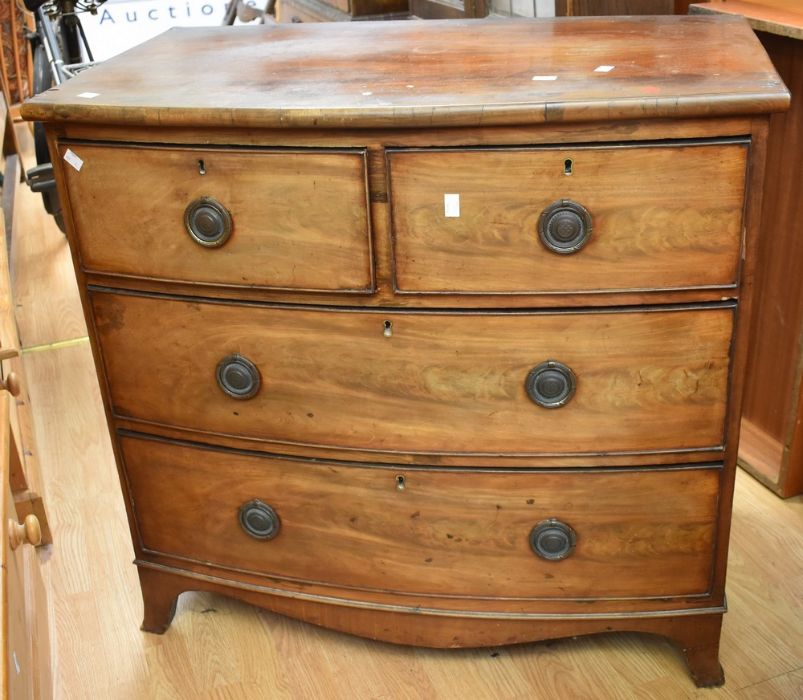 George III bow front chest of two above two drawers, in mahogany