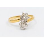 An 18ct gold and diamond 'toi-et-moi' flower head ring, claw set round brilliant cut diamonds, total