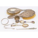 A collection of silver items to include: silver mounted hair brushes, button hook, two spoons, egg