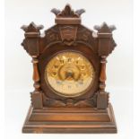 Early 20th Century carved mantle clock with gold face, Arabic numerals, eight day