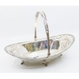 A George V silver oval fruit basket, pierced foliate and scroll decoration to bowl ends, rim and