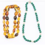 A collection of two bead necklaces to include a malachite and cultured pearl necklace with gold