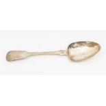 An early 19th Century Channels Island silver fiddle pattern table spoon, the handle engraved with