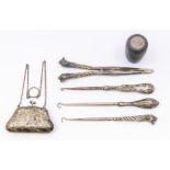 A collection of silver to include: monogrammed purse, three button hooks and glove stretcher, and