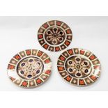 Two Royal Crown Derby large dinner plates and one medium 1128 Imari, all three are second quality