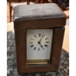 A French early 20th Century brass carriage clock with leather travel case, white enamel dial with