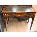 A small-proportioned Edwardian ladies' desk with green leather writing surface, serpentine front,